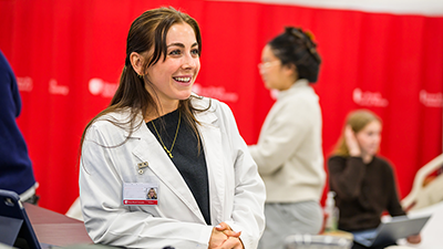 A student smiling in a simulation lab.